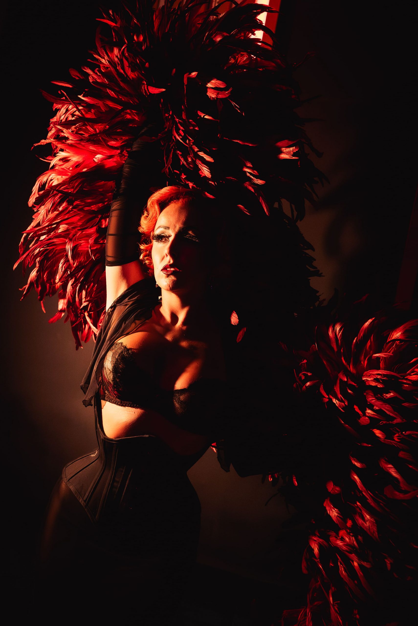 Cabaret performer in red light at Imperial